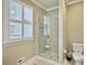 Modern bathroom with walk-in shower, plantation shutters, and tiled floors at 102 Flud St, Summerville, SC 29483