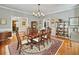 Formal dining room with hardwood floors, chandelier, and antique china cabinet at 102 Flud St, Summerville, SC 29483