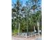Wooden boat lift structure with tall post and surrounding fence at 4239 Tom Point Rd, Hollywood, SC 29449