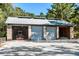 Brick garage with three roll-up doors, offering plenty of storage space at 4239 Tom Point Rd, Hollywood, SC 29449