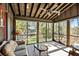 Relaxing screened porch with wooden floors and comfortable seating, overlooking the wooded backyard at 4239 Tom Point Rd, Hollywood, SC 29449