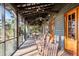 Relaxing screened porch with rocking chairs and string lights at 4239 Tom Point Rd, Hollywood, SC 29449