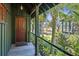 Charming porch with wooden flooring, offering tranquil views of the backyard and water at 4239 Tom Point Rd, Hollywood, SC 29449