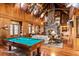 Spacious game room with a pool table, vaulted ceiling, and hardwood floors at 4239 Tom Point Rd, Hollywood, SC 29449