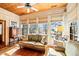 Bright sunroom with wicker furniture and water views at 4239 Tom Point Rd, Hollywood, SC 29449