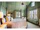 Peaceful bedroom with high ceilings, a ceiling fan, and a view of the outdoors at 4239 Tom Point Rd, Hollywood, SC 29449