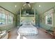 Green-walled bedroom with a leafy patterned bedspread at 4239 Tom Point Rd, Hollywood, SC 29449