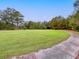 Expansive grassy lawn with brick and concrete walkway at 4239 Tom Point Rd, Hollywood, SC 29449