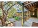 Wooden deck porch with railing overlooking lush backyard and trees at 4239 Tom Point Rd, Hollywood, SC 29449