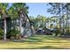Two charming homes with dark wood siding and landscaping at 4239 Tom Point Rd, Hollywood, SC 29449
