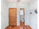 Simple bathroom with white toilet and wood floors at 4239 Tom Point Rd, Hollywood, SC 29449