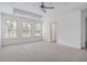 Bright bedroom with three windows and ceiling fan at 8735 Revival Rd, North Charleston, SC 29420