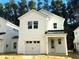 Modern farmhouse style home with dark metal roof and white siding at 297 Claret Cup Way, Charleston, SC 29414
