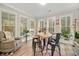 Bright sunroom with ample windows, comfortable seating, and a live-edge table at 112 Canewood Ln, Ridgeville, SC 29472