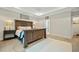 Main bedroom with plush carpet, large bed, and plenty of natural light at 112 Canewood Ln, Ridgeville, SC 29472