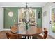Charming dining room with a round wooden table and view of backyard at 112 Canewood Ln, Ridgeville, SC 29472