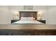 Main bedroom with a wooden bed frame and neutral color scheme at 112 Canewood Ln, Ridgeville, SC 29472