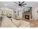 Living room with sectional sofa, fireplace, and large TV at 112 Canewood Ln, Ridgeville, SC 29472