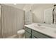 Clean bathroom with a teal vanity, shower, and striped curtain at 112 Canewood Ln, Ridgeville, SC 29472