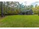 Gray house nestled in a wooded lot with large backyard at 112 Canewood Ln, Ridgeville, SC 29472