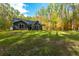 Gray house with a back porch and large backyard at 112 Canewood Ln, Ridgeville, SC 29472