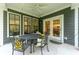 Covered porch with seating area and view of kitchen at 112 Canewood Ln, Ridgeville, SC 29472
