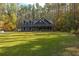 Two-story home with gray siding, porch, and green lawn at 112 Canewood Ln, Ridgeville, SC 29472