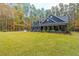 Gray farmhouse with large front yard and wooded background at 112 Canewood Ln, Ridgeville, SC 29472