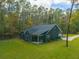 Dark gray house with large backyard and wooded area at 112 Canewood Ln, Ridgeville, SC 29472