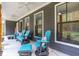 Relaxing front porch with blue rocking chairs and ceiling fans at 112 Canewood Ln, Ridgeville, SC 29472