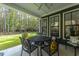 Relaxing back patio with metal table and chairs, overlooking a grassy yard and trees at 112 Canewood Ln, Ridgeville, SC 29472