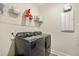 Convenient laundry room with washer, dryer, and overhead shelving at 112 Canewood Ln, Ridgeville, SC 29472