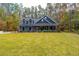 Two-story gray house with a covered porch and green lawn at 112 Canewood Ln, Ridgeville, SC 29472