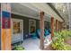 Inviting front porch with teal rocking chairs and wood posts at 112 Canewood Ln, Ridgeville, SC 29472