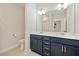 Elegant bathroom with a double vanity, navy blue cabinets and gold hardware at 112 Canewood Ln, Ridgeville, SC 29472