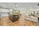 Open concept kitchen with island and living room view at 112 Canewood Ln, Ridgeville, SC 29472