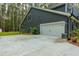 Gray house with a white garage door and landscaping at 112 Canewood Ln, Ridgeville, SC 29472