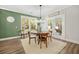 Bright dining area with round wooden table and access to backyard at 112 Canewood Ln, Ridgeville, SC 29472