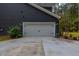 Attached garage with light gray door and landscaping at 112 Canewood Ln, Ridgeville, SC 29472