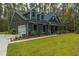 Gray farmhouse with a long driveway and wooded setting at 112 Canewood Ln, Ridgeville, SC 29472