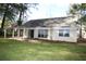 House with a large backyard, patio, and mature trees at 110 Smithfield Ave, Summerville, SC 29485