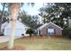 Brick and shingle exterior of charming house with two-car garage and landscaped lawn at 110 Smithfield Ave, Summerville, SC 29485