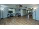 Open living room with wood-look floors and view into kitchen at 565 Estates Dr, Walterboro, SC 29488