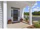 Inviting front porch with black door and planters at 472 Rowley Ln, Summerville, SC 29486