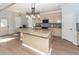 Modern kitchen with granite island and beige cabinets at 127 Meadow Wood Rd, Summerville, SC 29486