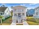 Two-story light purple house with white trim, double garage, and front porch at 2312 Bucktail Ct, Mount Pleasant, SC 29466