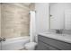 Small bathroom with gray vanity, a tub, and beige tile at 2312 Bucktail Ct, Mount Pleasant, SC 29466