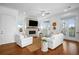Bright living room with white sofas, fireplace, and hardwood floors at 2312 Bucktail Ct, Mount Pleasant, SC 29466
