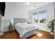 Bright bedroom with gray platform bed and hardwood floors, overlooking a pond at 2312 Bucktail Ct, Mount Pleasant, SC 29466
