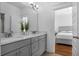 Double vanity bathroom with gray cabinets and a view into a bedroom at 2312 Bucktail Ct, Mount Pleasant, SC 29466